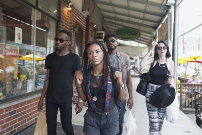 A group of friends walking down a street.