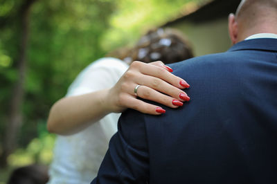 Midsection of couple holding hands