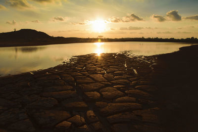 Scenic view of lake against sky during sunset