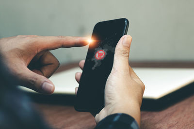 Midsection of man using mobile phone