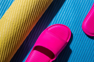 High angle view of slippers on beach mat