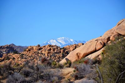 Scenic view of mountains against clear blue sky