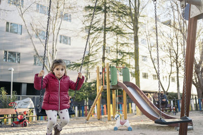 Girl playing in playground during winter