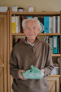 Portrait of man wearing mask at home