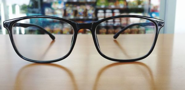 Close-up of eyeglasses on wooden table