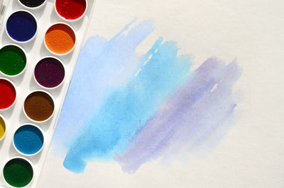 High angle view of watercolor paints on paper