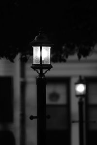 Close-up of illuminated street light at night