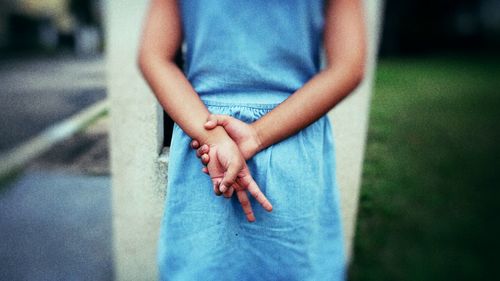 Midsection of woman standing in park