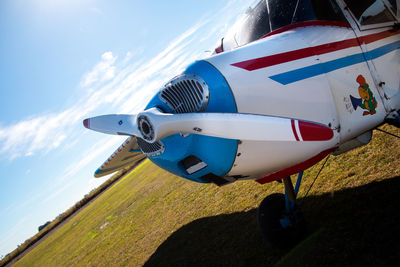 Side view of airplane on landscape against sky