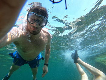 Young man swimming in sea