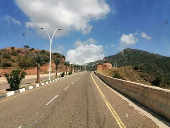 Road by street against sky