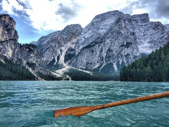 Scenic view of lake by mountains against sky