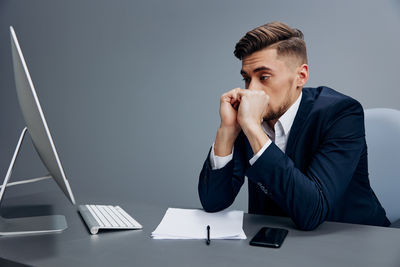 Young man using laptop at office