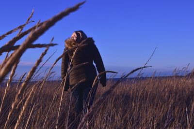 Woman on field against sky