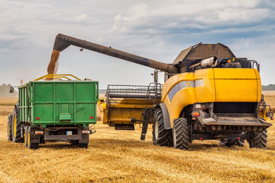 Barn on field against sky