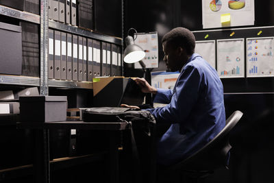 Rear view of man working in office