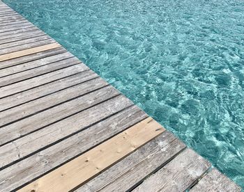 High angle view of boardwalk by swimming pool