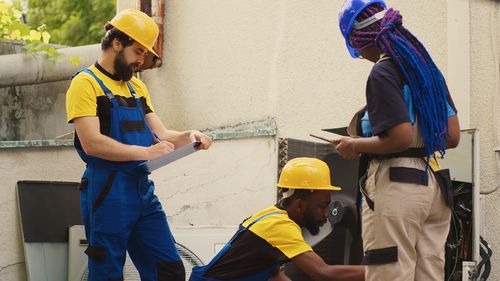 Rear view of people working at construction site