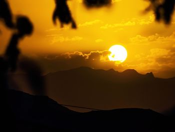 Scenic view of silhouette mountains against sky during sunset