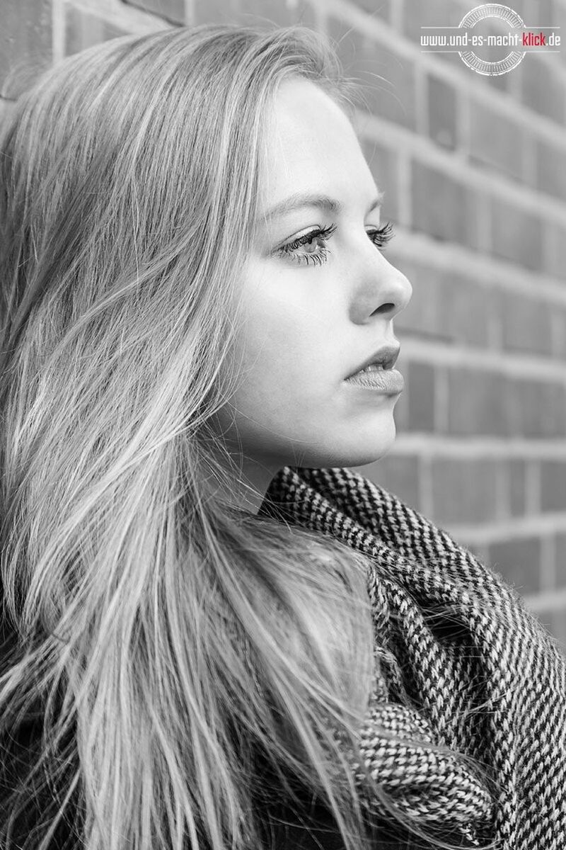 portrait, headshot, hair, one person, young adult, long hair, hairstyle, looking, beauty, leisure activity, lifestyles, young women, real people, looking away, adult, beautiful woman, women, focus on foreground, contemplation, warm clothing, brick, profile view