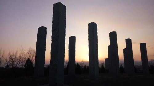 Silhouette built structure against clear sky during sunset