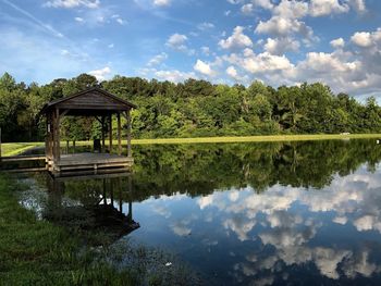 Built structure by lake against sky