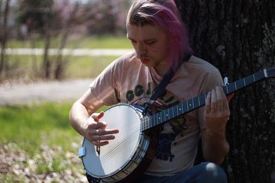 Close-up of woman playing guitar