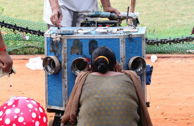 Rear view of people sitting outdoors