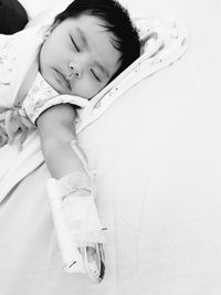 High angle view of girl sleeping on bed