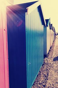 Buildings on beach against blue sky