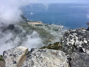 High angle view of rocks in sea against sky