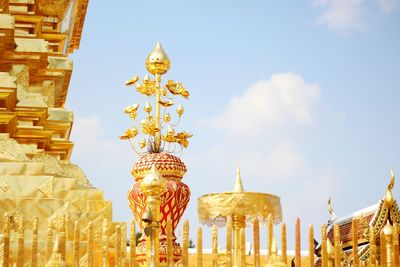 Low angle view of statue in temple against sky