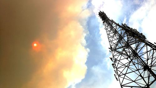 Low angle view of silhouette crane against sky during sunset