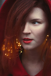 Close up redhead woman with glowing fairy lights portrait picture