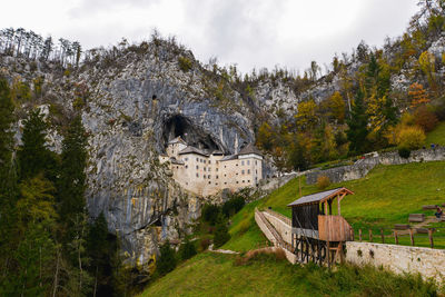 Castle on field against mountains