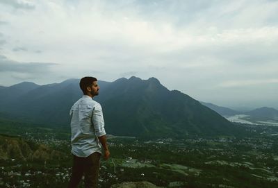 Rear view of man standing on mountain