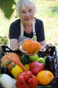 Portrait of smiling woman holding food