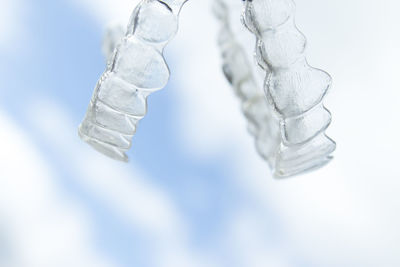 Close-up of dental prosthetic equipment against sky