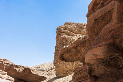 Low angle view of rock formation against sky