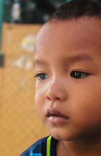 Close-up portrait of cute girl looking away