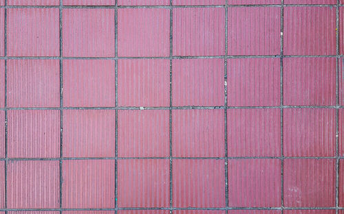 High angle view of pink and brick wall