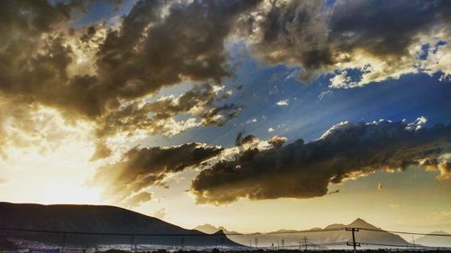 Scenic view of storm clouds over mountains