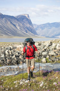 Man backpacking through akshayak pass