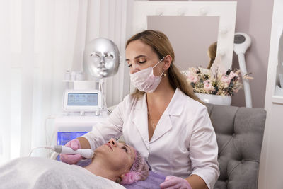 Micro current therapy. cosmetology beauty skincare procedure by beautician.