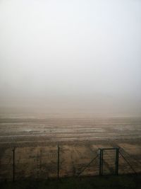Scenic view of landscape against sky during foggy weather