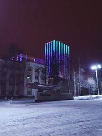 Illuminated city during winter at night