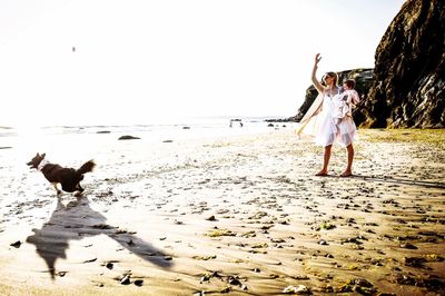 People on beach against sky