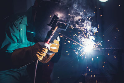 Midsection of man working at night