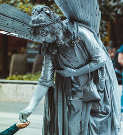 Statue of man holding sculpture