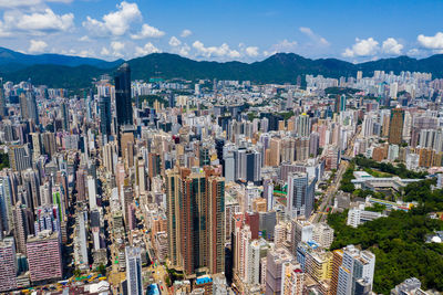 Aerial view of buildings in city against sky